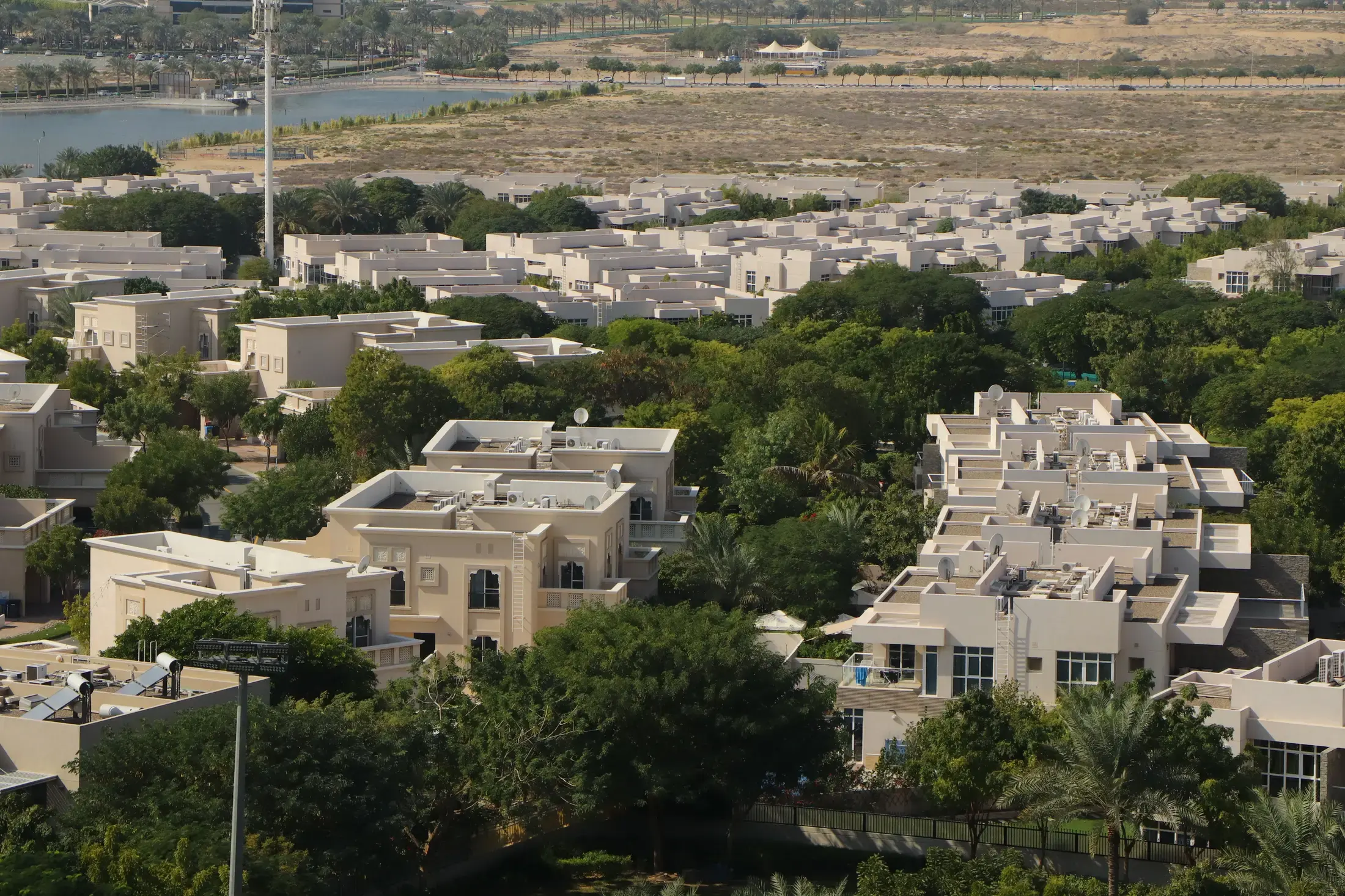 A low-rise villa community among trees, seen from above