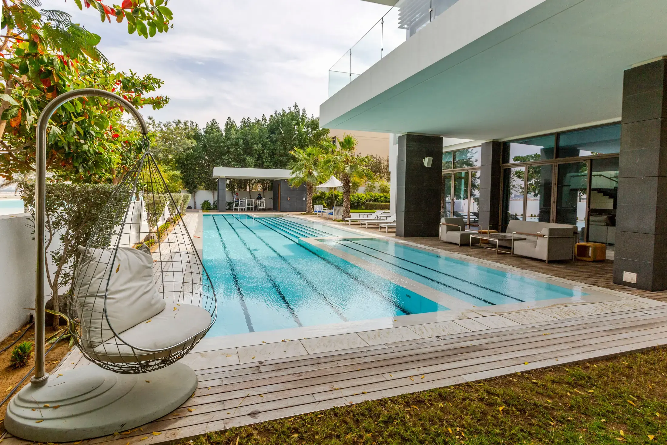 The poolside terrace and garden of a contemporary villa