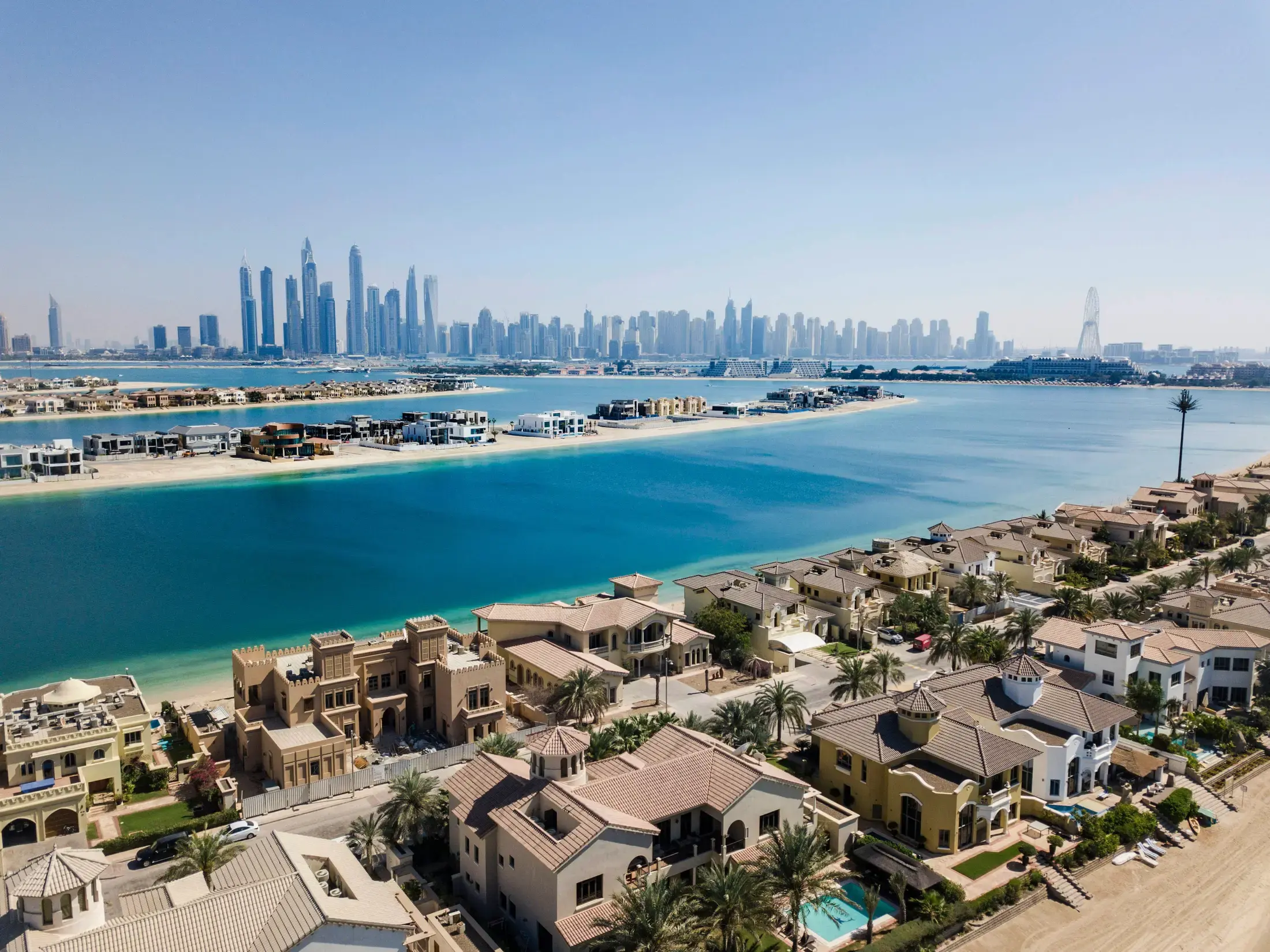 Palm Jumeirah villas with the Dubai Marina skyline beyond