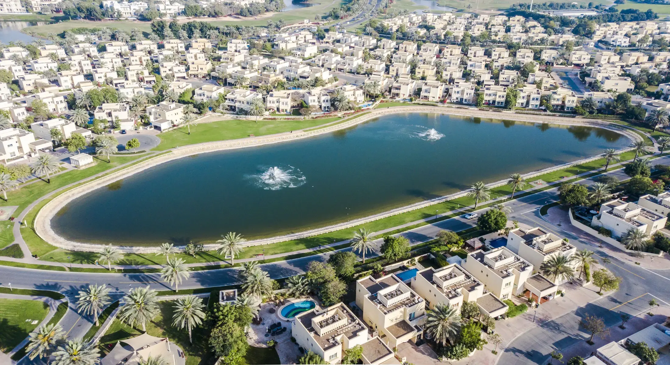 A lake at the centre of a villa community, seen from the air